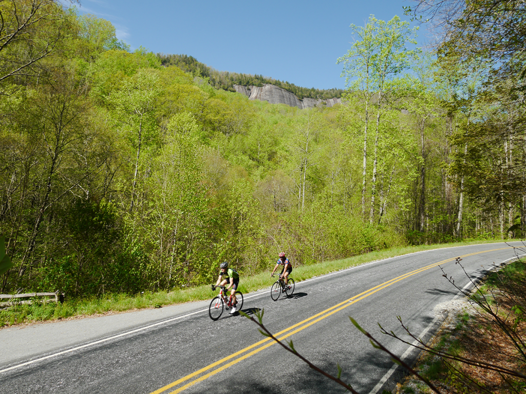 Cyclists make their way past Looking Glass Rock on the route of the Looking Glass Tour in Brevard.